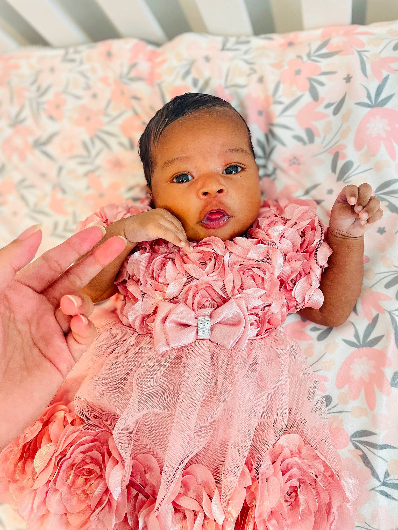 Aaliyah is registered to the contest to win money with this photo: baby, baby_toddler_clothing, child, comfort, dress, embellishment, facial_expression, finger, happy, linens, magenta, neck, pattern, person, petal, pink, product, skin, sleeve, textile