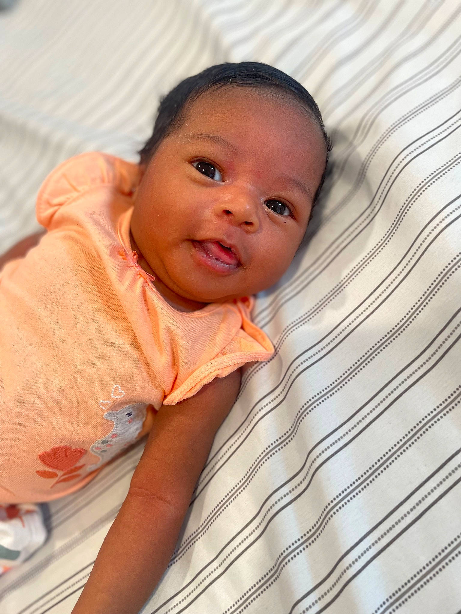 Aaliyah is registered to the contest to win money with this photo: baby, baby_toddler_clothing, cheek, child, comfort, eyebrow, flooring, hair, happy, iris, linens, lip, mouth, nose, person, skin, sleeve, smile, textile, toddler