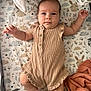 Alba participe au concours pour gagner de l'argent avec cette photo : baby, infant, crib, blanket, patterned_sheet, romper, pink_socks, cute, face, arms, legs, eyes, furniture, soft_toys, orange_blanket, sleeping_area, indoor, child, smiling, portrait