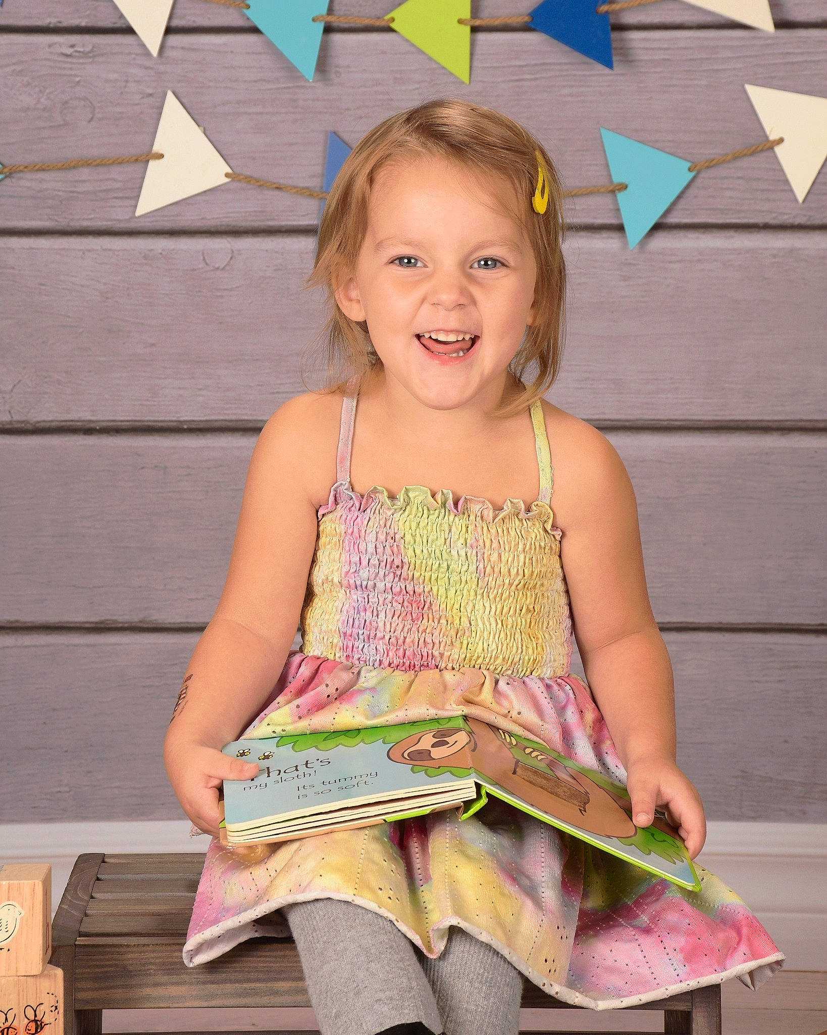 Kambria is registered to the contest to win money with this photo: book, child, design, event, fashion_design, fun, happy, joy, leisure, office_supplies, pattern, people, person, pink, publication, reading, sitting, sleeve, smile, t_shirt