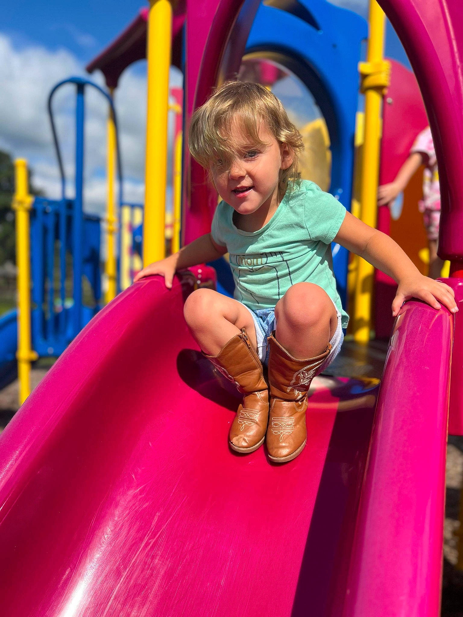 Kambria is registered to the contest to win money with this photo: child, chute, city, event, fun, happy, leisure, magenta, outdoor_play_equipment, outdoor_recreation, person, pink, play, playground, playground_slide, purple, recreation, shorts, sky, smile