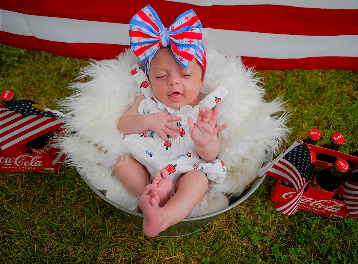Kanyn is registered to the contest to win money with this photo: accessories, americanflag, baby, clothing, costume, dress, face, flag, formalwear, grass, hat, head, lawn, person, photography, plant, portrait, pottedplant, summer, tie
