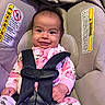 Nayeli joined the competition — help win amazing prizes! baby, child, car_seat, safety_harness, floral_onesie, smiling, tongue_out, infant, cute, happy, indoors, seatbelt, warning_label, fabric, plush, person, portrait, baby_clothing, sitting, closeup
