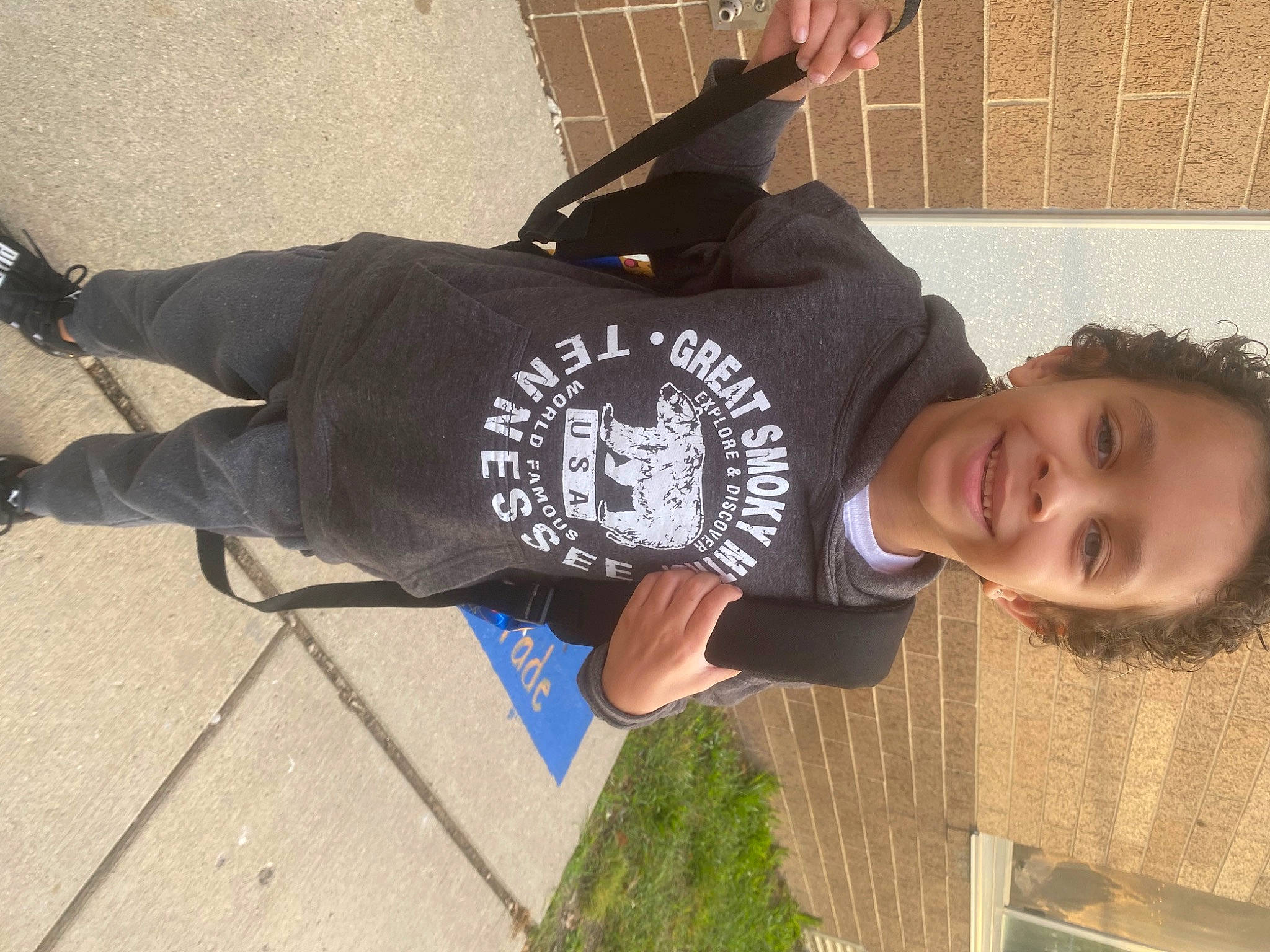 Gregory is registered to the contest to win money with this photo: asphalt, cap, concrete, cool, elbow, eyewear, fun, grass, happy, hat, joy, leisure, person, sleeve, smile, street_fashion, t_shirt, toddler, waist