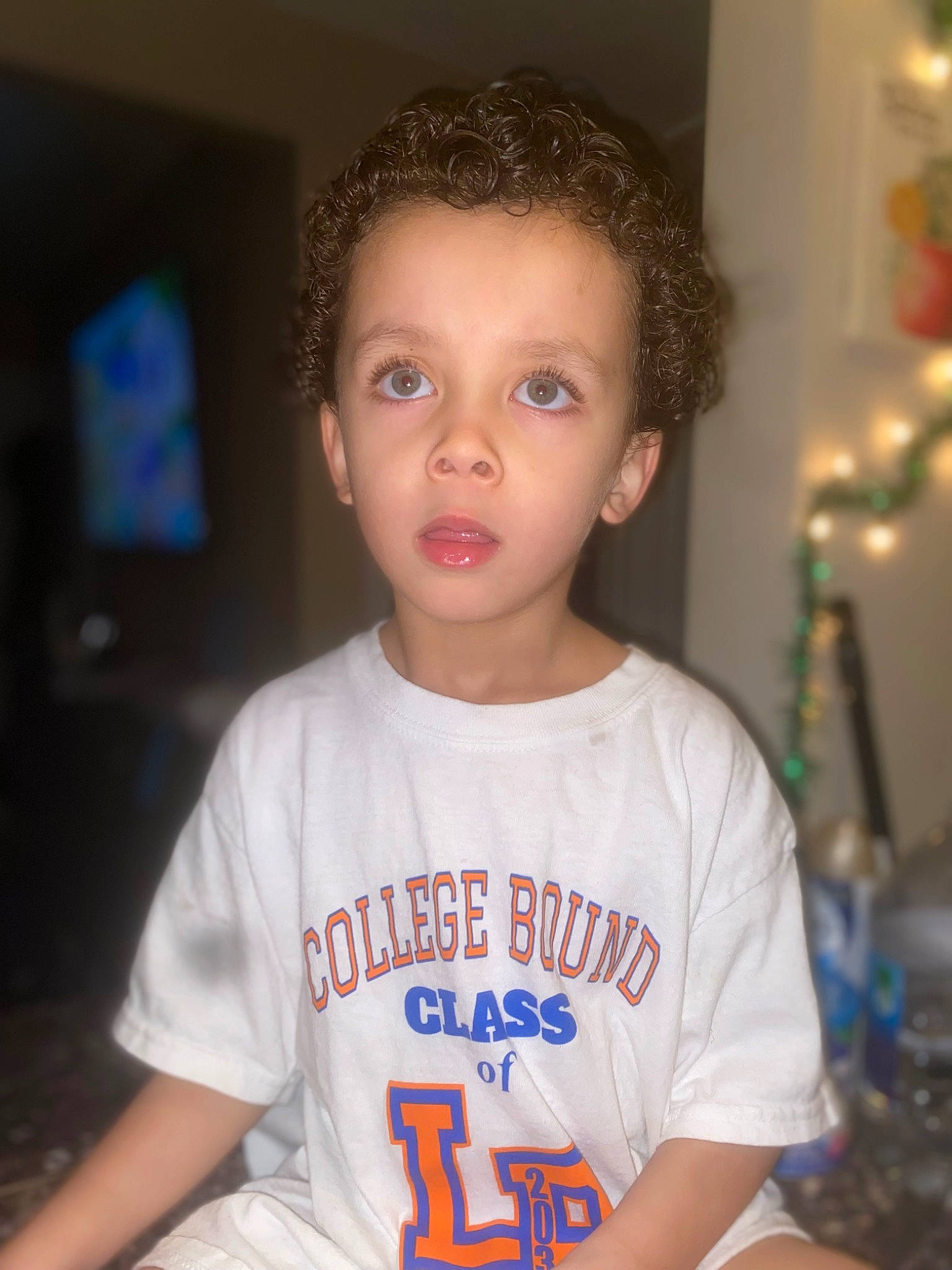 Izaiah is registered to the contest to win money with this photo: baby_toddler_clothing, cheek, child, chin, elbow, electric_blue, eyebrow, facial_expression, forehead, fun, hairstyle, happy, head, iris, jersey, nose, person, sleeve, standing, t_shirt