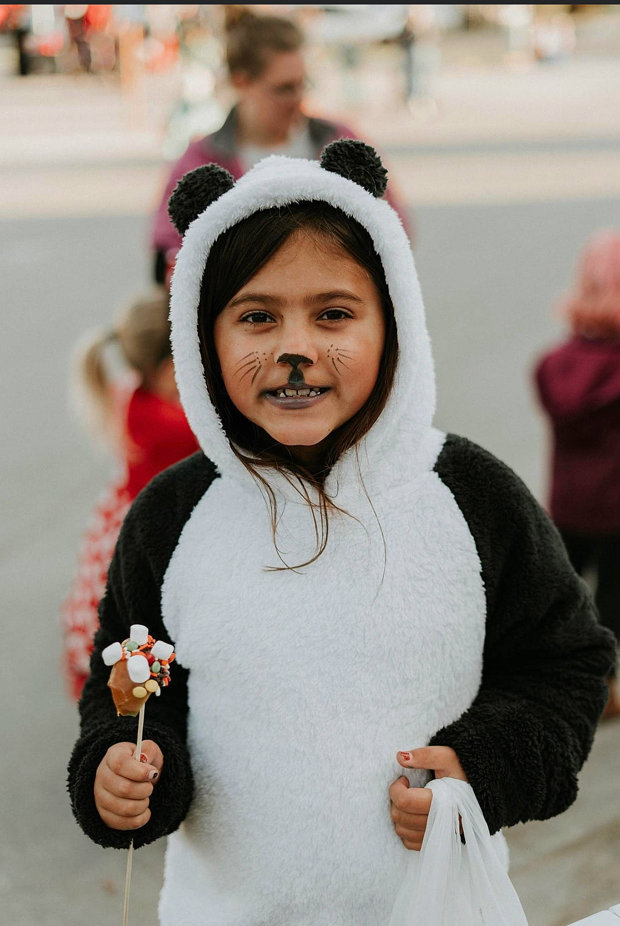 Carrie is registered to the contest to win money with this photo: child, costume, event, fashion_accessory, freezing, fun, fur, gesture, glove, happy, hoodie, jewellery, joy, laugh, person, recreation, sleeve, smile, street, tradition