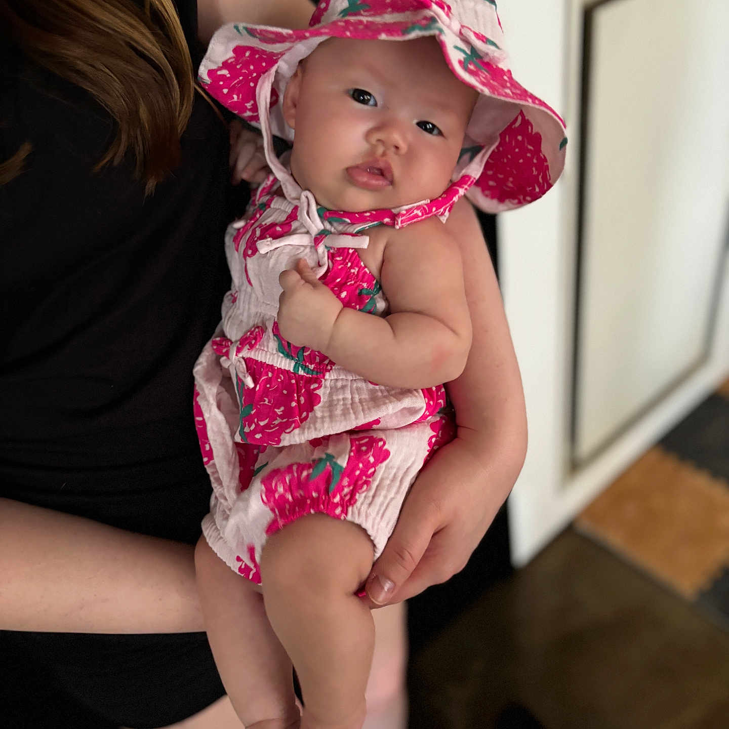Somi joined the competition — help win amazing prizes! adult, baby, baby_girl, black_clothing, child, clothing, curious, cute, floral, foot, hand, hat, holding, indoor, infant, people, person, pink, portrait, skin