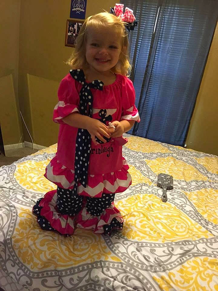 Brinleigh is registered to the contest to win money with this photo: art, baby_toddler_clothing, carpet, child, embellishment, event, floor, flooring, fun, head, joy, linens, magenta, pattern, person, pink, purple, red, room, smile