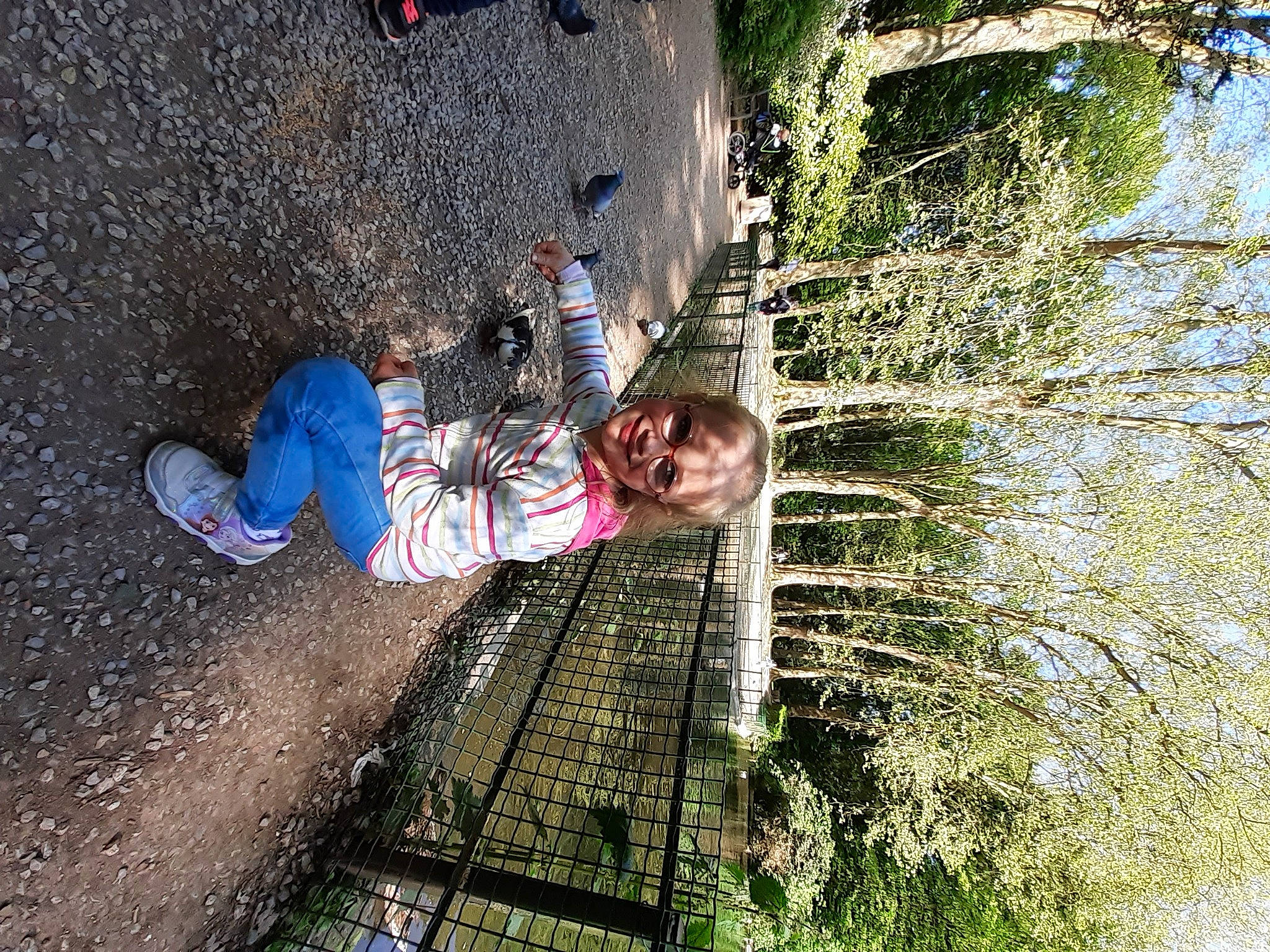Lola participe au concours pour gagner de l'argent avec cette photo : child, concrete, fun, grass, joy, landscape, leaf, leisure, outdoor_shoe, people_in_nature, person, plant, recreation, reflection, shadow, smile, soil, toddler, tree, walking_shoe