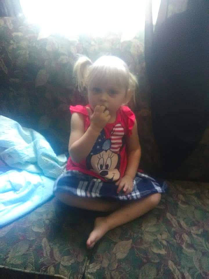 Cylee is registered to the contest to win money with this photo: baby_toddler_clothing, barefoot, child, comfort, flooring, foot, fun, grass, happy, human_leg, lap, leisure, person, recreation, sandal, shorts, sitting, t_shirt, toddler, tree