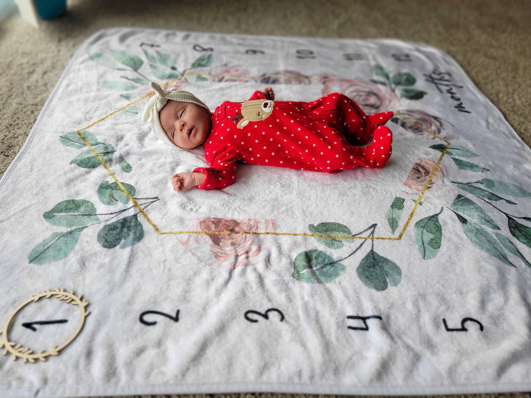 Cora is registered to the contest to win money with this photo: art, baby, baby_toddler_clothing, bed_sheet, bedding, child, comfort, craft, flooring, leaf, linens, needlework, pattern, person, rectangle, room, sleeve, tablecloth, textile, toddler