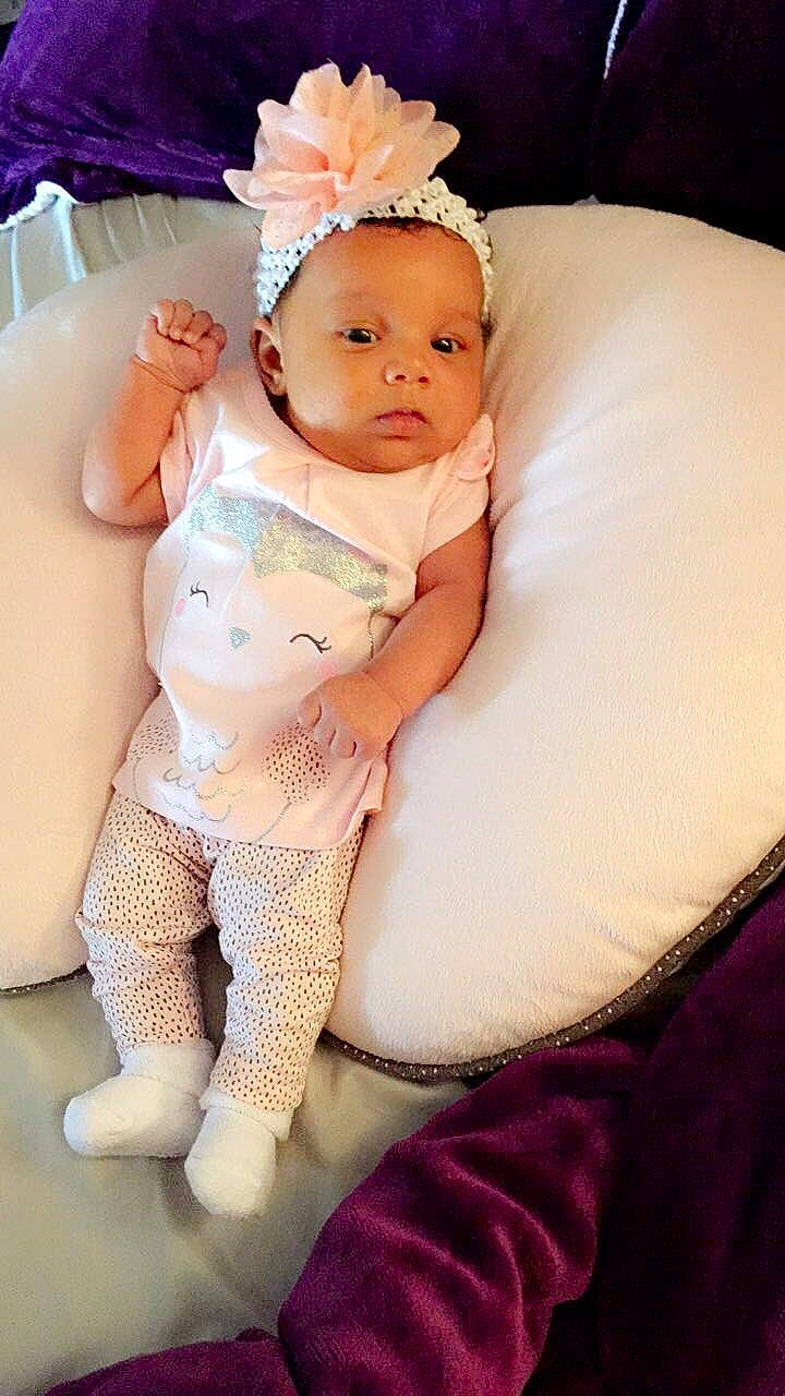 Margaret is registered to the contest to win money with this photo: abdomen, arm, baby, child, finger, hair_accessory, headgear, person, pink, product, skin, toddler, trunk