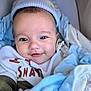 baby, blanket, blue, child, closeup, clothing, cozy, cute, face, happy, hat, indoors, infant, newborn, person, portrait, smiling, soft, warm, white