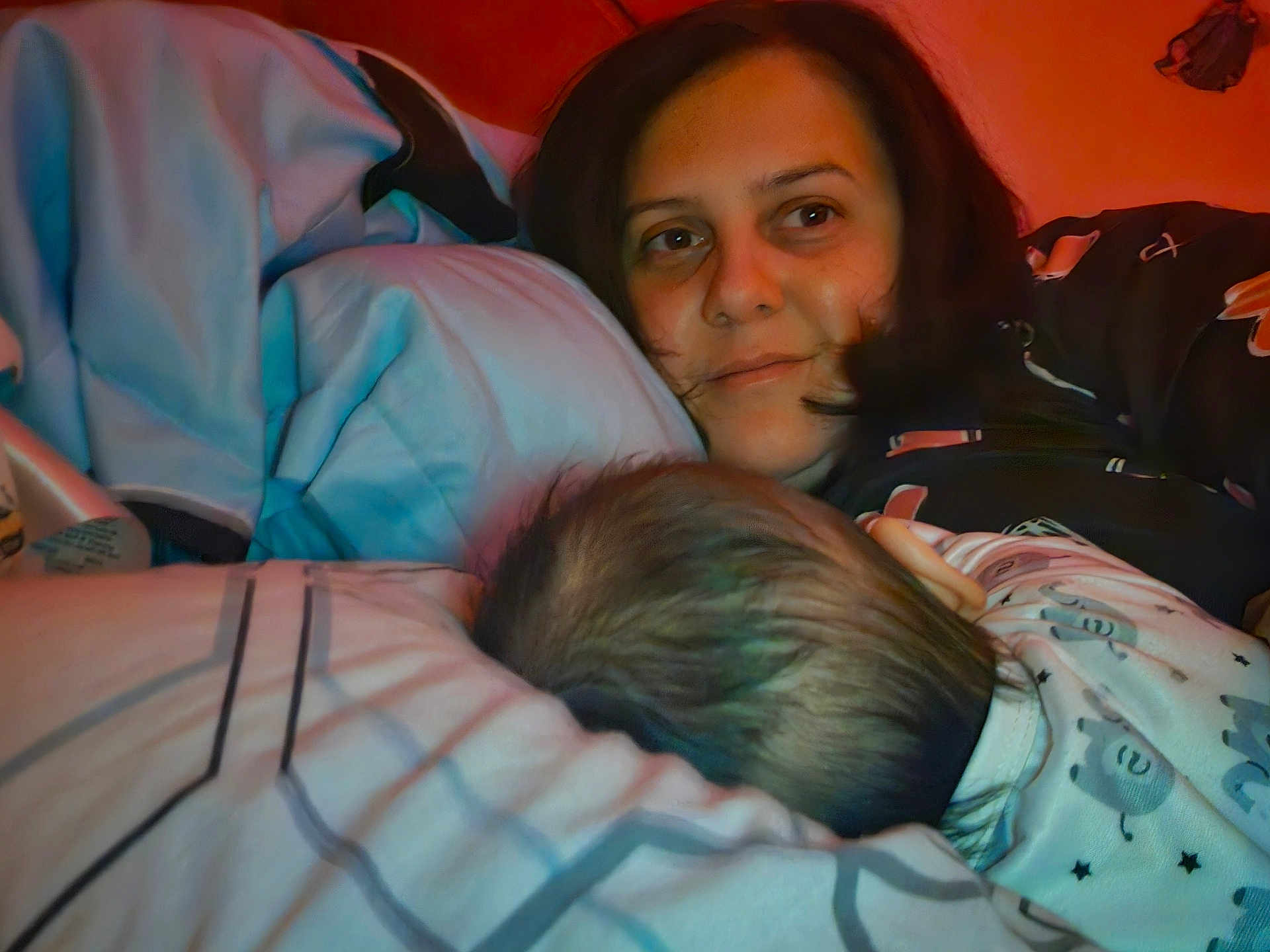 Iris Calissa Maria joined the competition — help win amazing prizes! woman, baby, bed, pillow, blanket, sleepwear, indoor, resting, face, hair, comfort, family, parent, child, night, warm_light, cozy, intimate, closeup, portrait