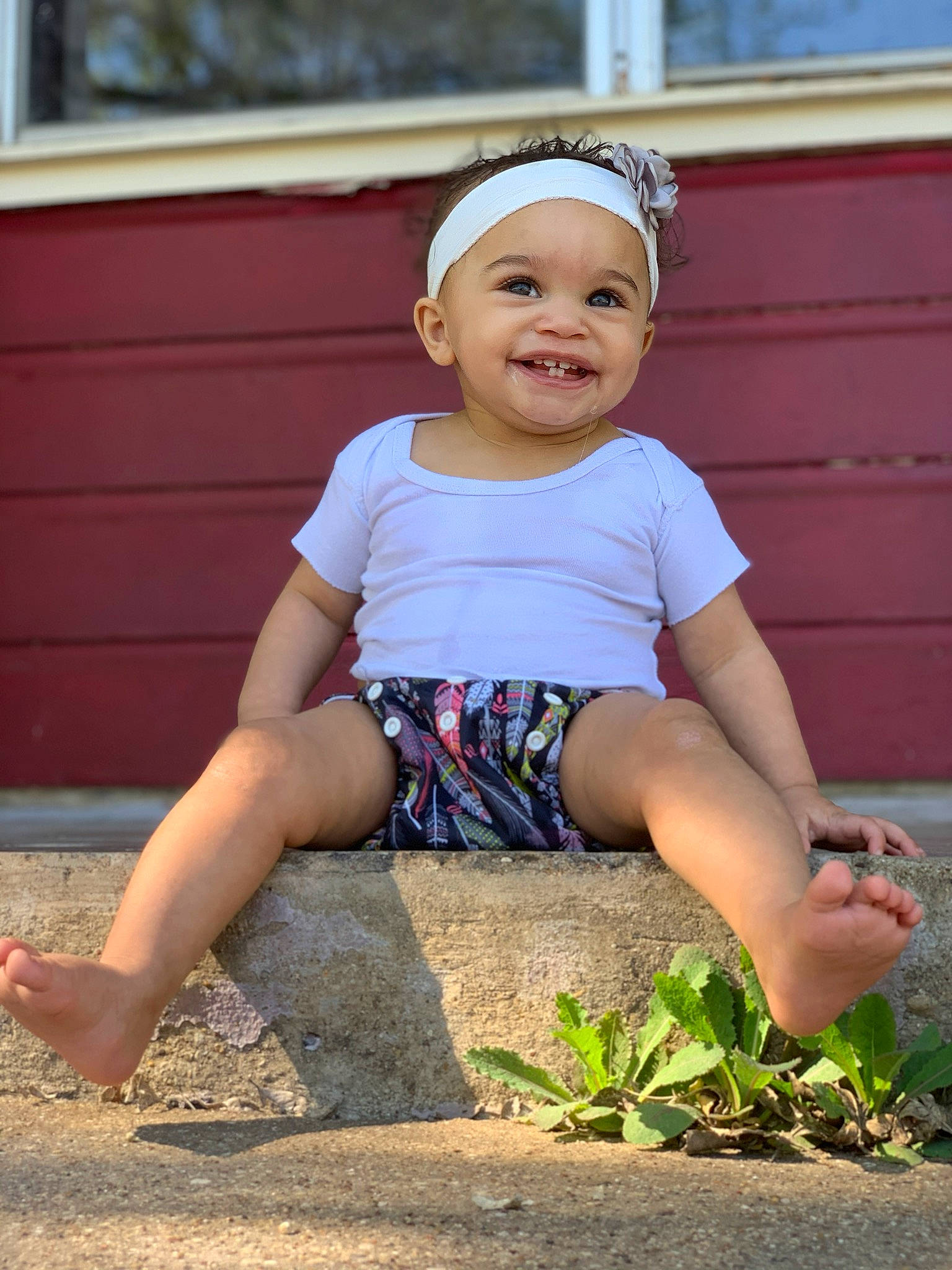Lilyana is registered to the contest to win money with this photo: baby_toddler_clothing, blond, child, child_model, facial_expression, happy, head, headband, headgear, headwear, joy, leg, people, person, photography, plant, play, shorts, sitting, smile