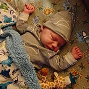 Isaac is registered to the contest to win money with this photo: animal_print, baby, blanket, child, cozy, crib, cute, giraffe, hat, indoor, infant, mattress, newborn, pacifier, peaceful, plush_toy, resting, sleeping, sleepwear, soft