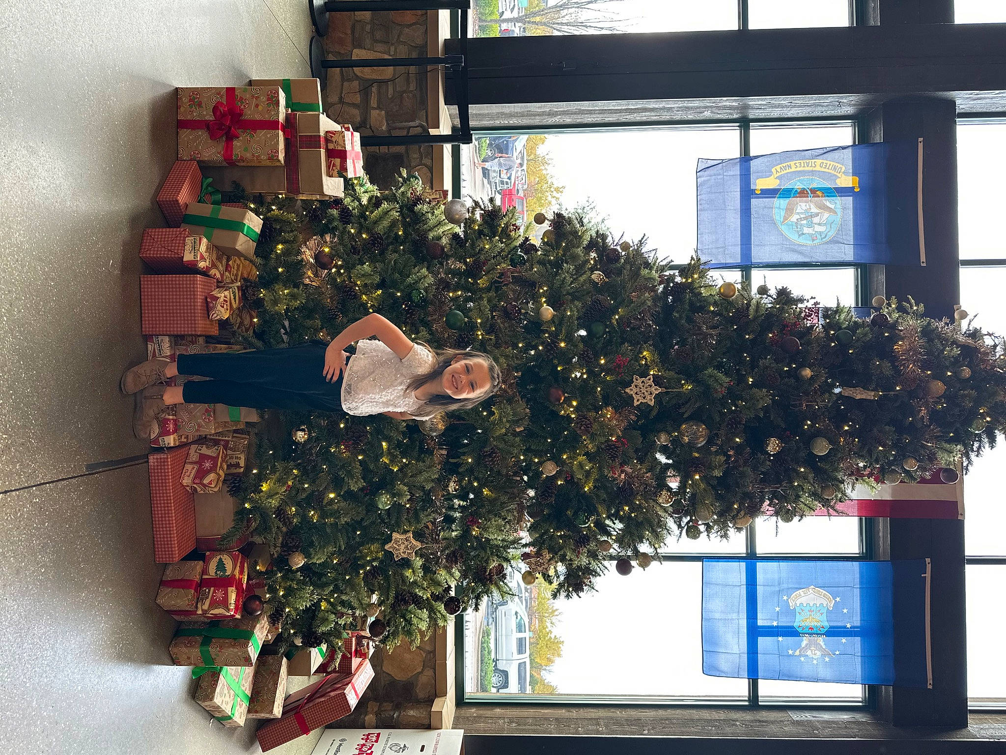 Payton is registered to the contest to win money with this photo: building, carmine, christmas, christmas_decoration, christmas_eve, christmas_ornament, christmas_tree, conifer, event, evergreen, facade, floral_design, flowerpot, holiday, interior_design, joy, ornament, person, plant, tree