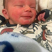 Ryker joined the competition — help win amazing prizes! newborn, baby, blanket, sleeping, smile, infant, onesie, dinosaur, cozy, cute, child, soft, warm, face, hand, portrait, indoors, resting, toddler, sleepy