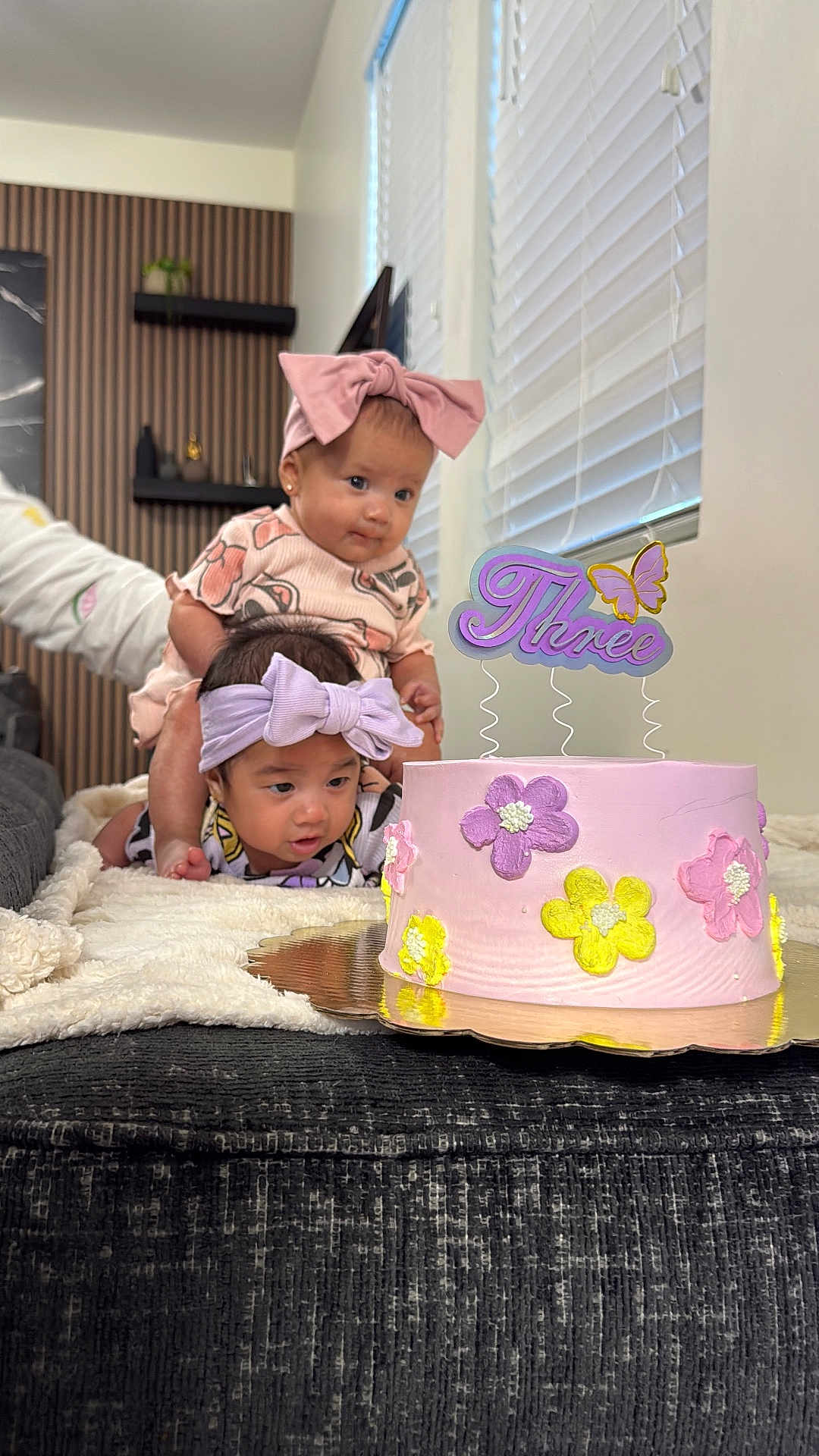 Luna And Adriana is registered to the contest to win money with this photo: baby, birthday_cake, blanket, bow, celebration, child, curious, cute, decor, family, flower, headband, indoor, person, pink, purple, smiling, table, toddler, yellow