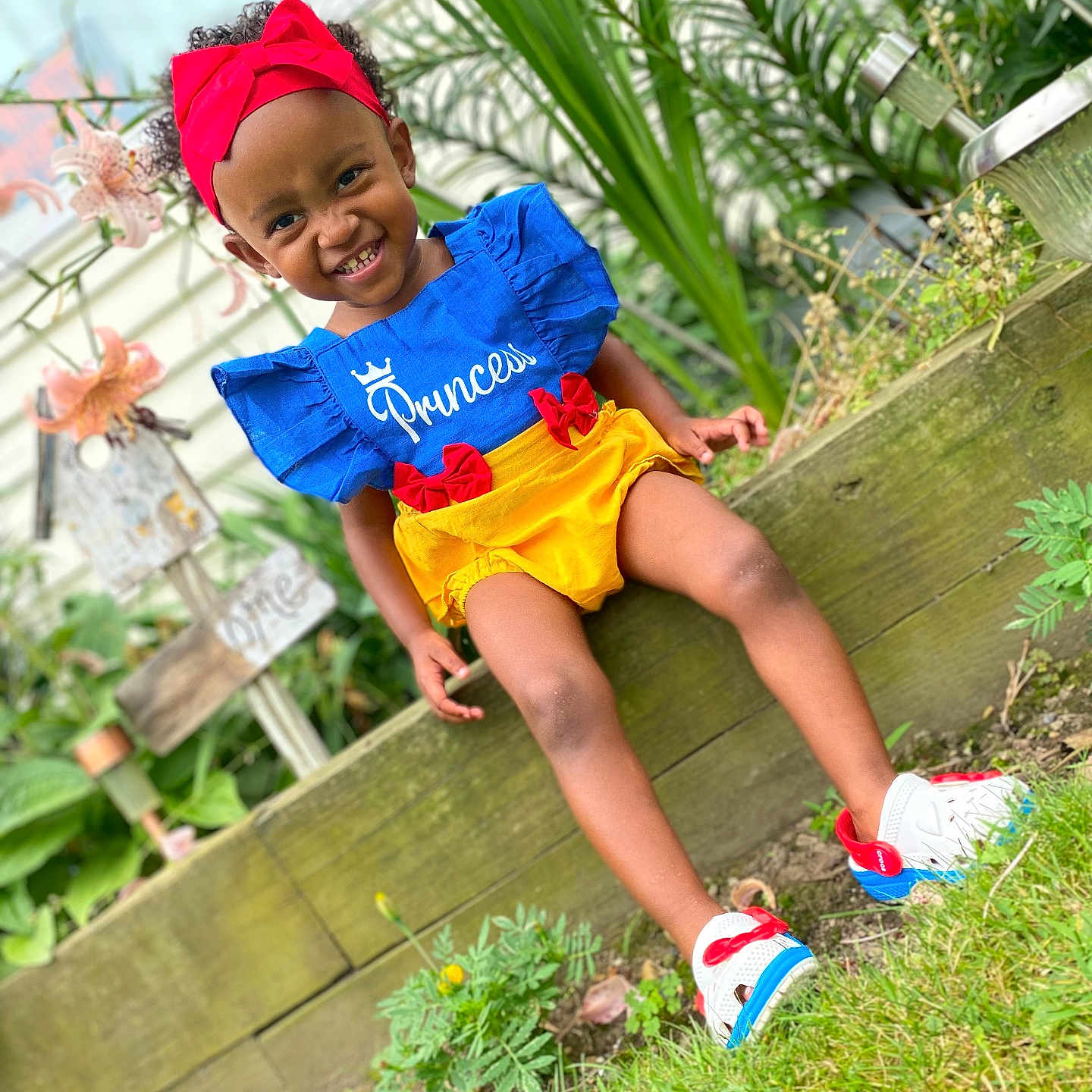 Princess is registered to the contest to win money with this photo: backyard, clothing, face, footwear, head, jar, nature, outdoors, person, photography, plant, planter, portrait, pottedplant, pottery, shoe, shorts, summer, vase, yard