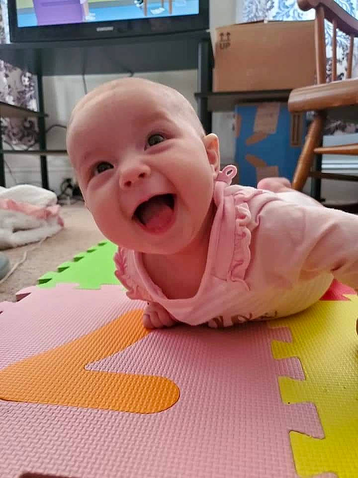 Kathleen is registered to the contest to win money with this photo: baby, baby_laughing, child, crawling, facial_expression, head, mouth, person, play, smile, toddler, tummy_time
