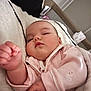 baby, sleeping, infant, pink_clothing, blanket, cozy, cute, child, soft, indoors, peaceful, portrait, chubby_cheeks, rest, toddler, hand, face, young_child, comfort, warm