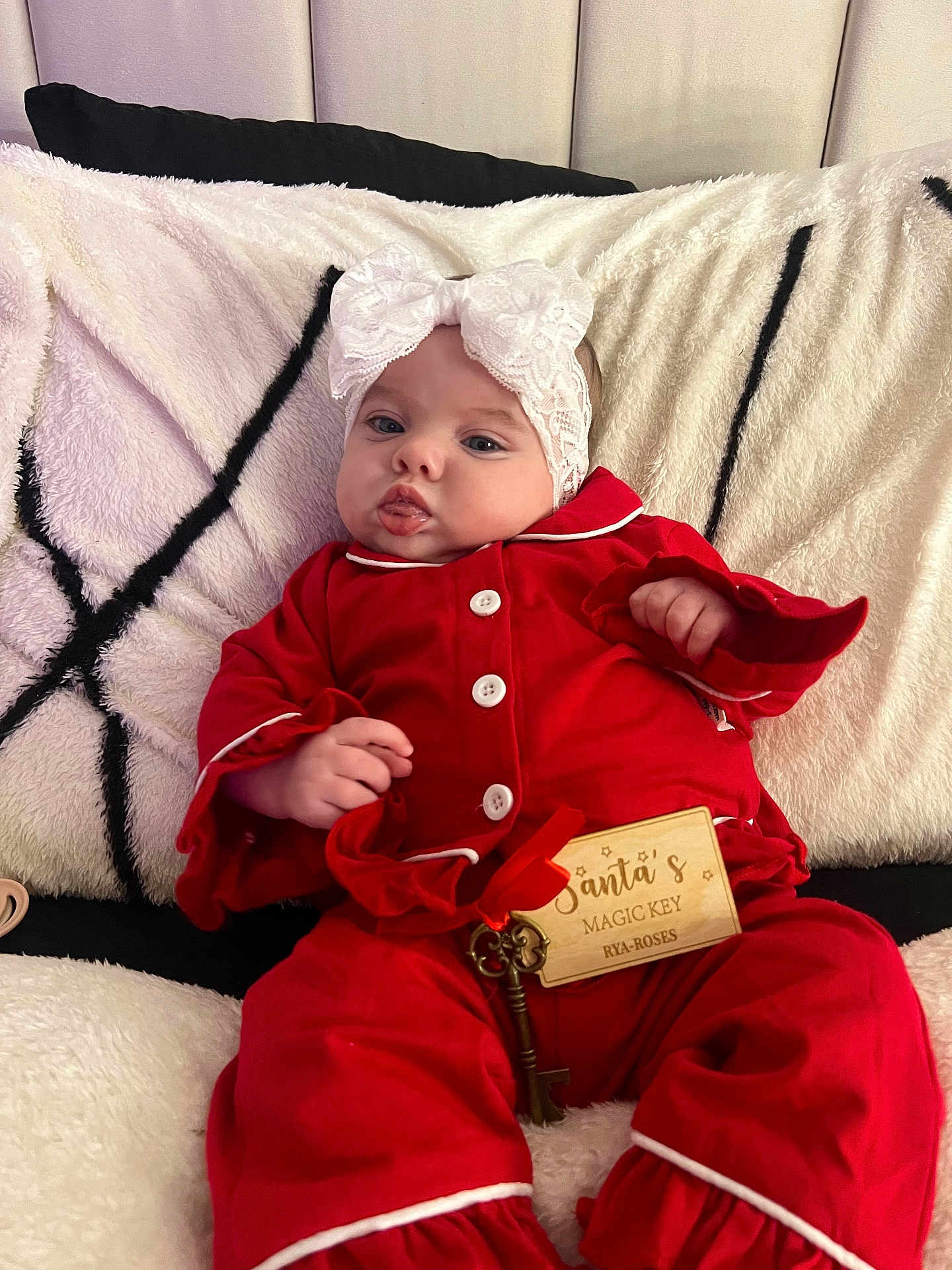 Rya-Rose joined the competition — help win amazing prizes! baby, infant, red_pajamas, headband, lace, bow, blanket, cozy, key, wooden_tag, holiday, christmas, cute, indoors, person, child, soft_texture, white, black, festive