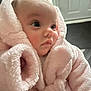 Rya-Rose is registered to the contest to win money with this photo: baby, infant, pink_robe, soft_texture, close_up, face, skin, curious_eyes, newborn, indoors, portrait, child, cute, warm_clothing, fluffy, wrapped, small, human, adorable, young