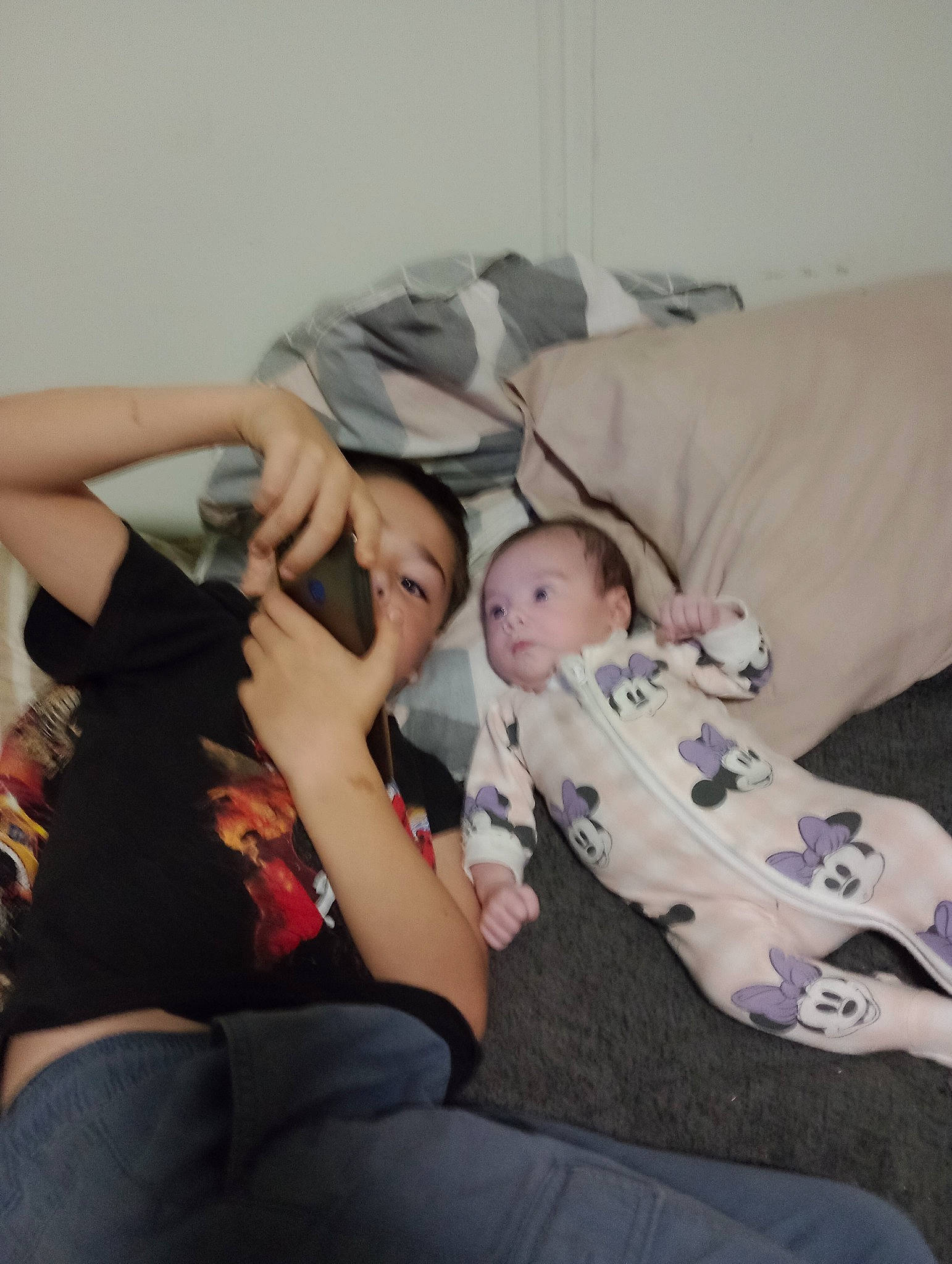 Leighton is registered to the contest to win money with this photo: abdomen, baby, baby_toddler_clothing, bedtime, child, comfort, elbow, fun, gesture, happy, human_leg, knee, lap, linens, nap, person, room, sitting, t_shirt, thigh