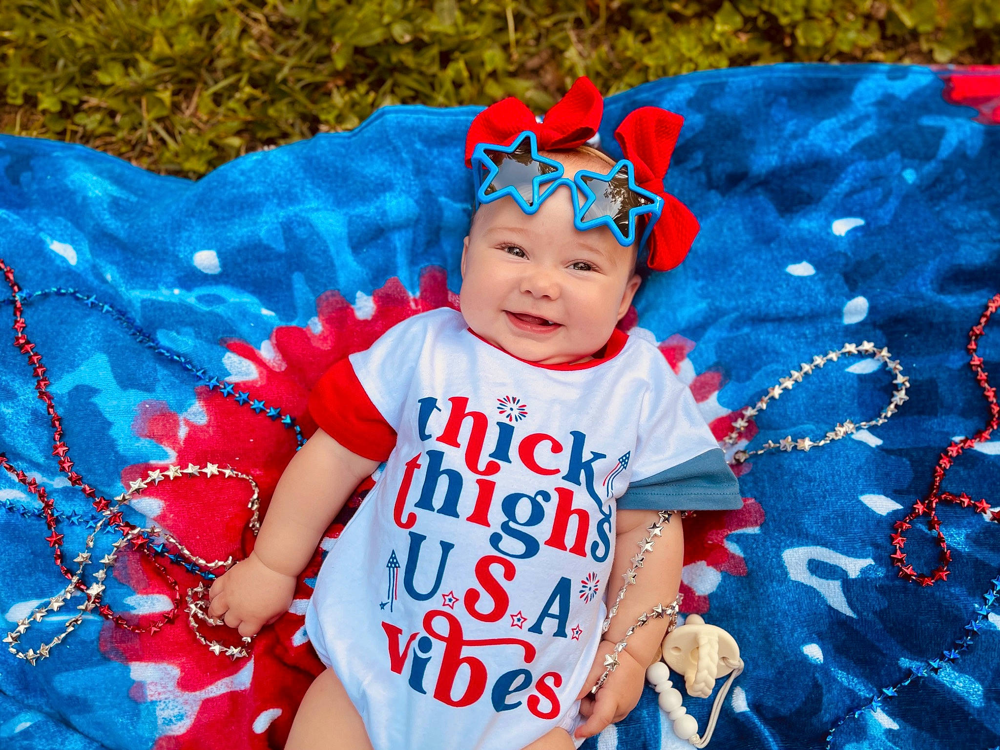 Molly is registered to the contest to win money with this photo: azure, baby, baby_toddler_clothing, blue, child, cool, electric_blue, event, fun, grass, happy, headwear, joy, magenta, pattern, people_in_nature, person, pink, sleeve, smile