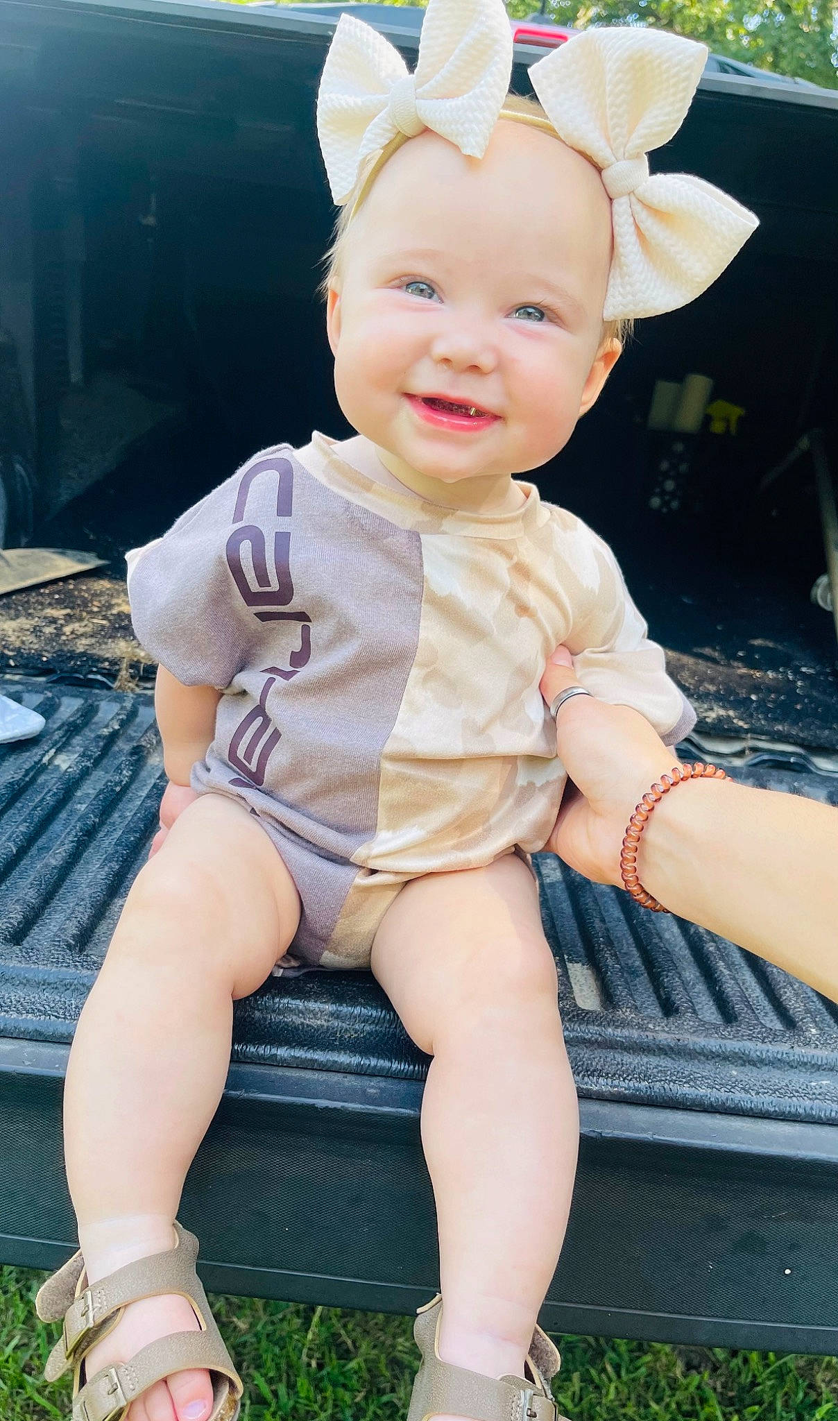 Molly joined the competition — help win amazing prizes! baby, baby_toddler_clothing, child, eye, face, facial_expression, flash_photography, fun, grass, happy, headband, human_leg, joy, knee, person, pink, skin, sleeve, smile, thigh