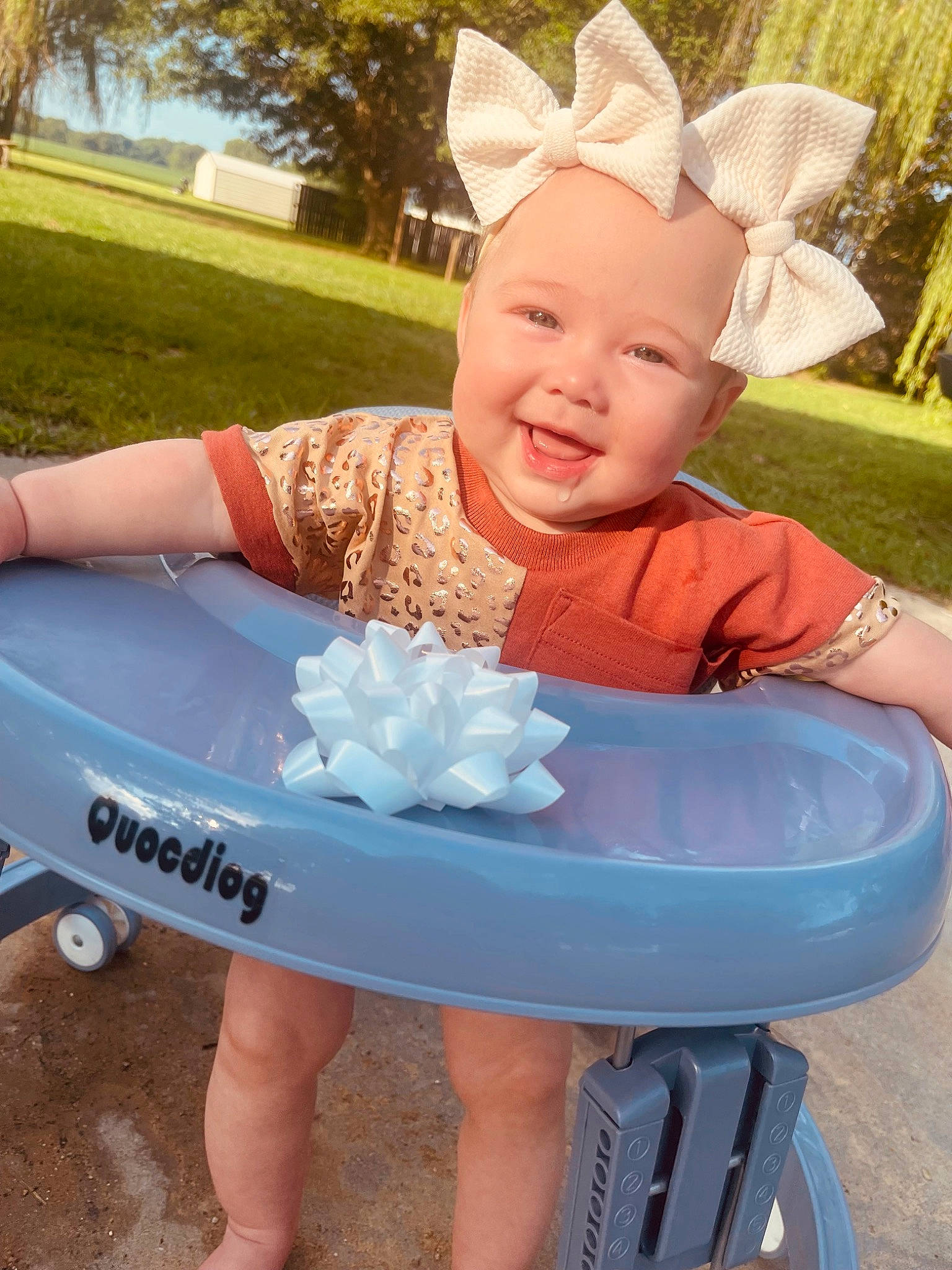 Molly joined the competition — help win amazing prizes! baby_toddler_clothing, child, costume_hat, electric_blue, fun, grass, happy, headband, joy, leisure, outdoor_furniture, party_supply, person, pink, plant, recreation, sandal, sitting, smile, table