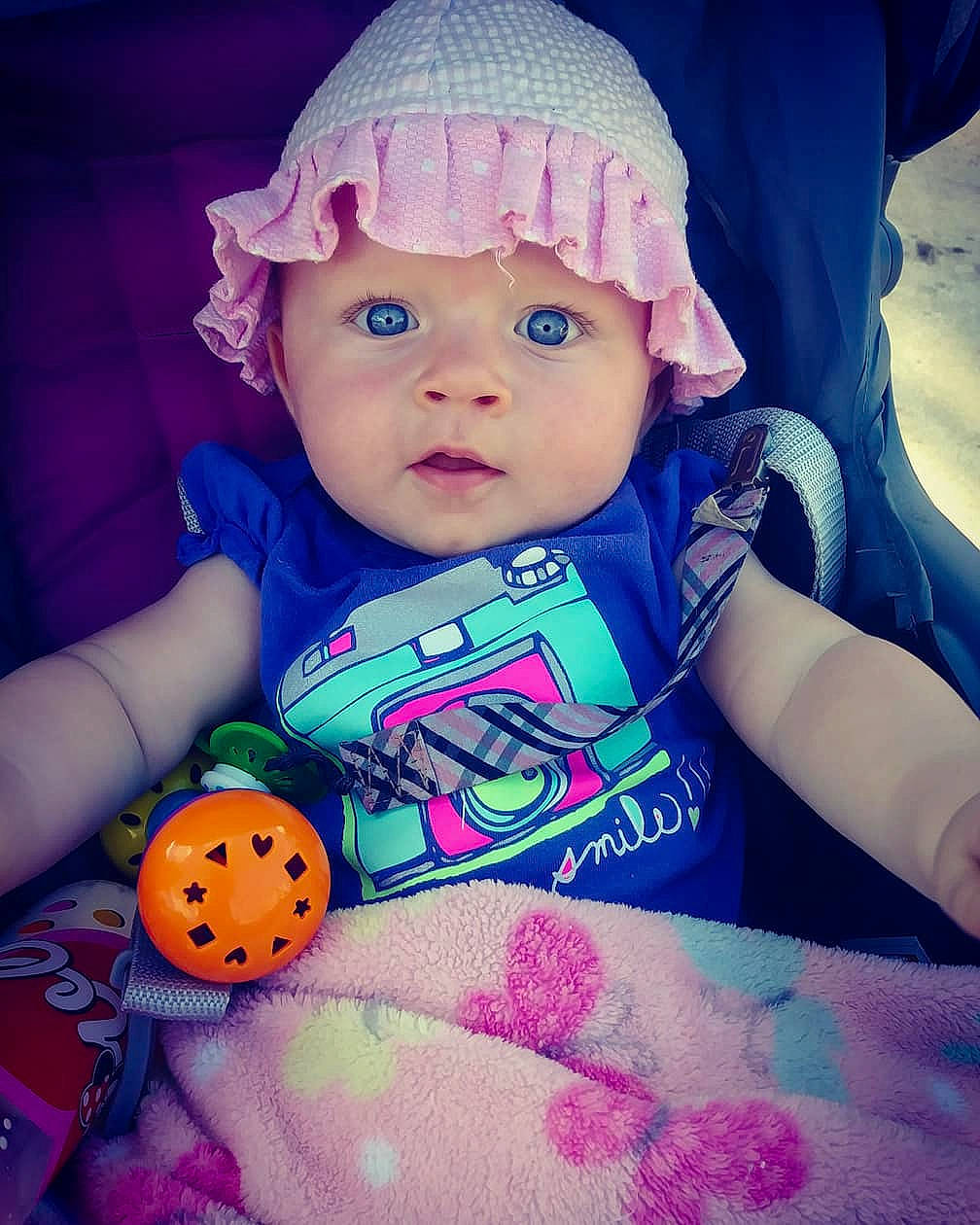 Baylee is registered to the contest to win money with this photo: blue, cheek, child, cool, eye, fun, girl, happiness, headgear, headwear, infant, iris, mouth, nose, person, pink, product, purple, skin, smile