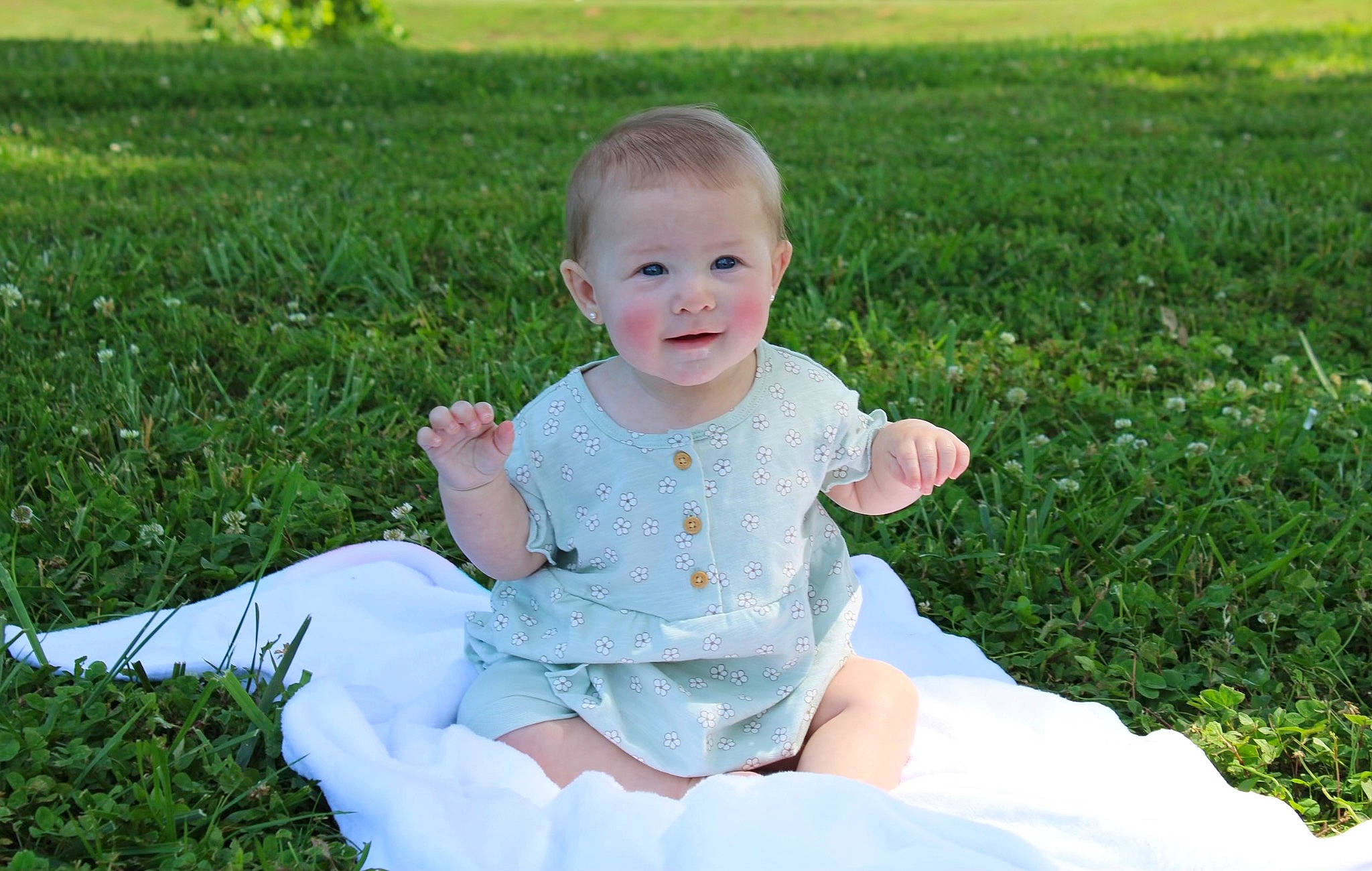 Olivia joined the competition — help win amazing prizes! baby, baby_toddler_clothing, child, dress, fun, grass, grass_family, happy, head, lawn, meadow, people_in_nature, person, plant, sitting, skin, sleeve, smile, summer, t_shirt