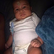 Kentrell joined the competition — help win amazing prizes! baby, bandage, bed, blanket, casual_snapshot, child, chubby_cheeks, cozy, face, hand, indoor, infant, leg, low_light, newborn, onesie, pacifier_clip, portrait, skin, staring