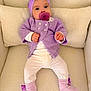 baby, infant, pacifier, headband, purple, lavender, knitwear, socks, armchair, cushion, cozy, cute, child, indoors, portrait, clothing, person, soft_texture, comfortable, relaxed