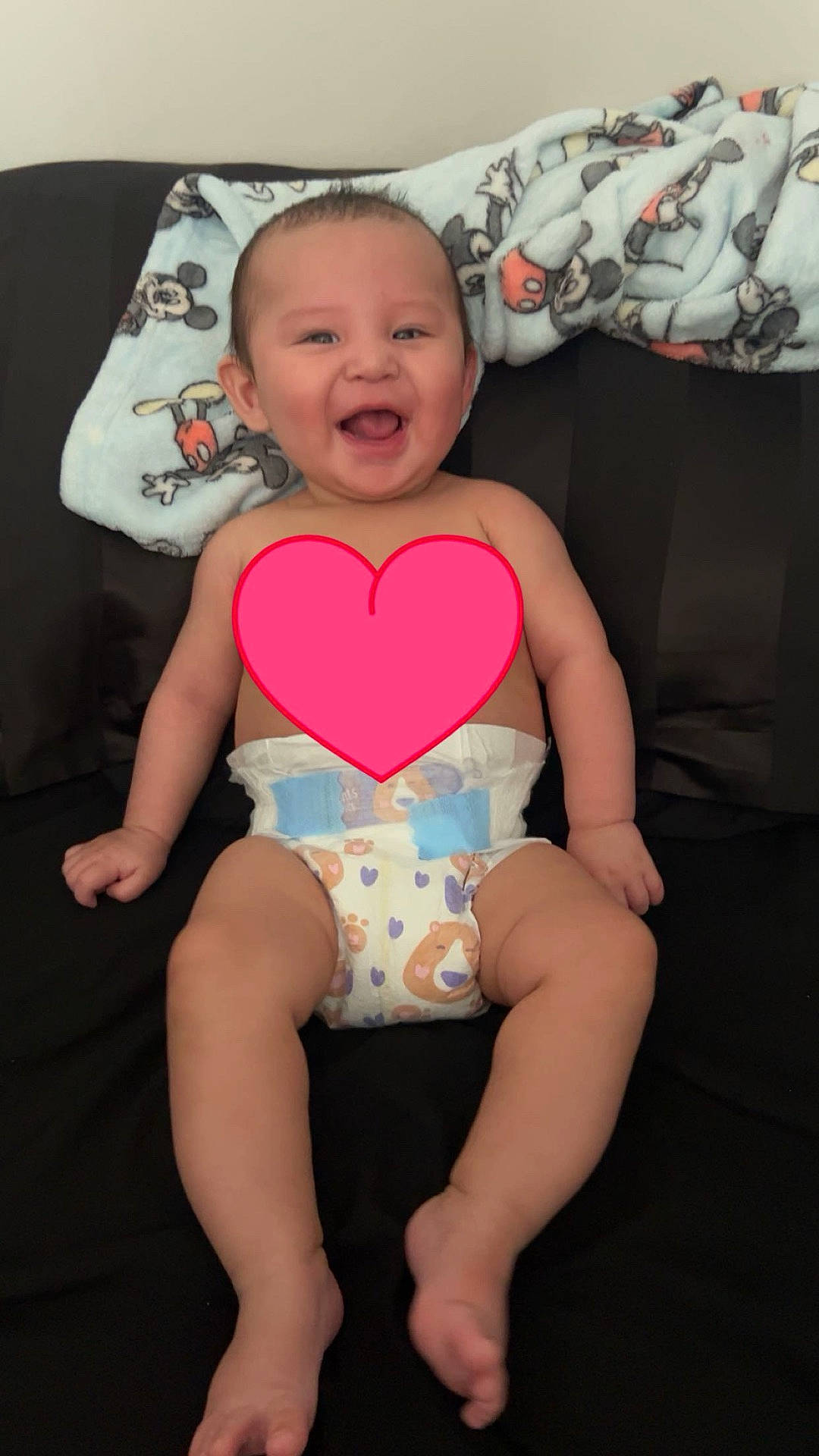 Waawaate is registered to the contest to win money with this photo: baby, bed, bedroom, clothing, couch, cushion, diaper, face, furniture, head, heart, homedecor, indoors, person, photography, pillow, portrait, room, shorts, sitting