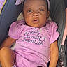 baby, infant, child, portrait, car_seat, pink_outfit, headband, bow, sitting, looking_at_camera, face, eyes, mouth, indoor, vehicle, clothing, onesie, sock, close_up, safe