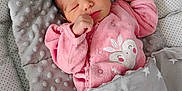 Kelly participe au concours pour gagner de l'argent avec cette photo : newborn, baby, sleeping, pink_outfit, blanket, pillow, star_pattern, cozy, infant, face, hand, closed_eyes, soft_texture, cute, resting, indoors, child, peaceful, wrapped, portrait