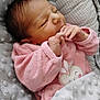newborn, baby, infant, sleeping, blanket, pink_clothing, soft_texture, cozy, cute, face, hand, resting, indoor, portrait, child, newborn_clothing, pattern, plush, cute_baby, peaceful