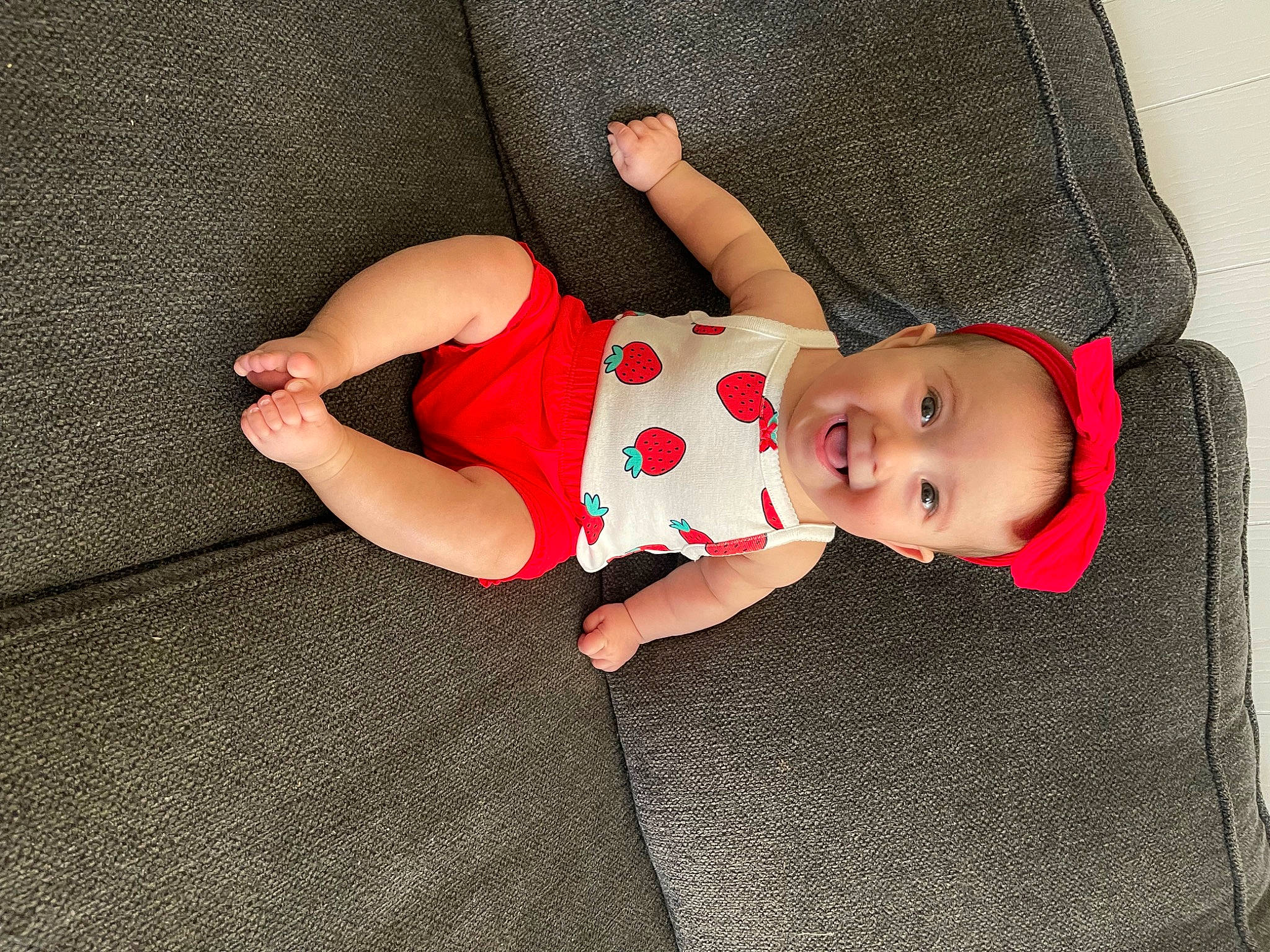 Sunni is registered to the contest to win money with this photo: arm, baby, baby_products, baby_toddler_clothing, child, comfort, face, foot, headgear, human_body, human_leg, joy, leg, linens, pattern, person, skin, sleeve, sock, thigh