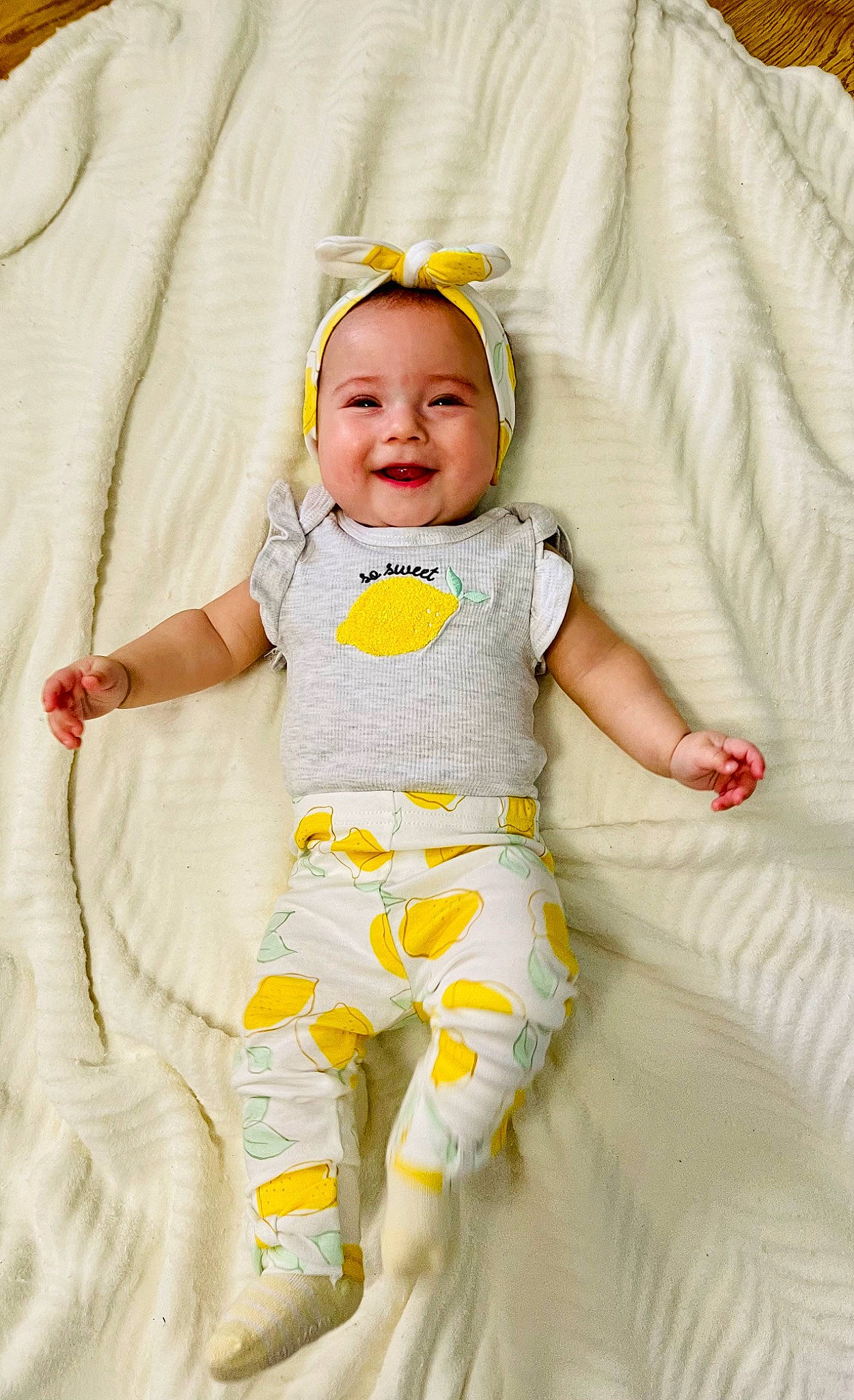 Sunni is registered to the contest to win money with this photo: baby, baby_products, baby_toddler_clothing, child, comfort, event, face, happy, hat, joy, linens, pattern, person, sitting, skin, sleeve, smile, t_shirt, textile, toddler