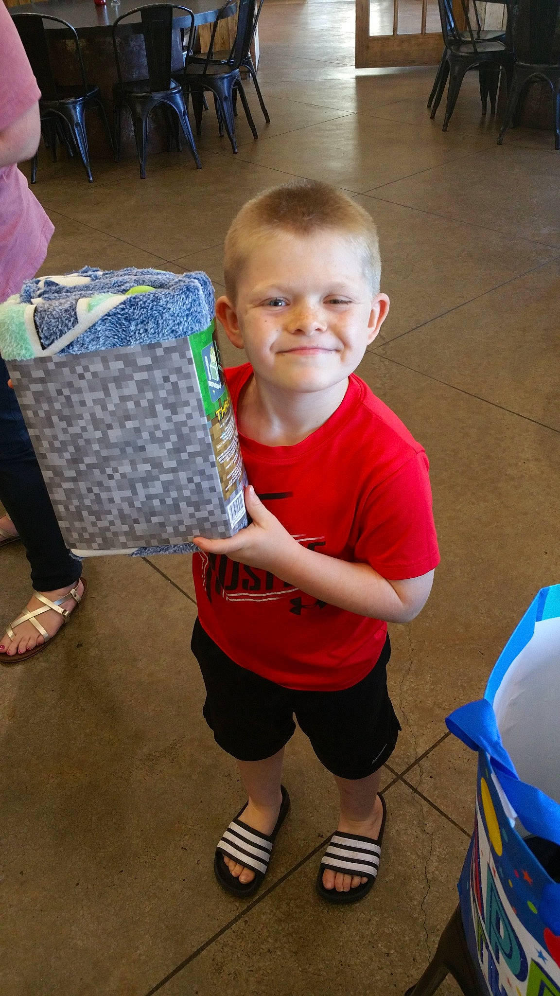 Benjamin is registered to the contest to win money with this photo: ankle, baby, child, flip_flops, floor, flooring, foot, joy, leg, person, play, sandal, shoe, slipper, sneakers, toddler, walking_shoe