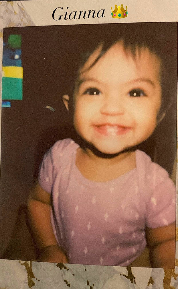 Gianna is registered to the contest to win money with this photo: art, baby, baby_toddler_clothing, cheek, child, chin, design, eyelash, fun, happy, iris, joy, nose, pattern, person, photo_caption, pink, rectangle, sleeve, smile