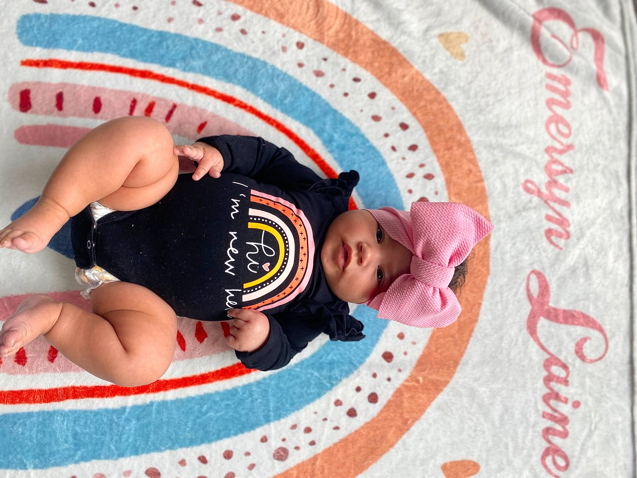 Emersyn is registered to the contest to win money with this photo: art, baby, baby_products, baby_toddler_clothing, barefoot, child, circle, comfort, font, foot, fun, happy, headwear, human_leg, leisure, linens, magenta, pattern, person, product