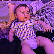 Luciano is registered to the contest to win money with this photo: baby, bed, bedroom, clothing, couch, cup, cushion, diaper, disposablecup, face, furniture, head, homedecor, indoors, person, photography, portrait, purple, room, shorts