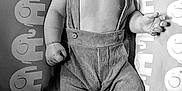 Micahel Jr joined the competition — help win amazing prizes! baby, infant, smiling, suspenders, pants, cushion, elephant_pattern, lying_down, happy, cute, child, portrait, black_and_white, soft_lighting, indoors, cozy, small_hands, feet, expression, relaxed