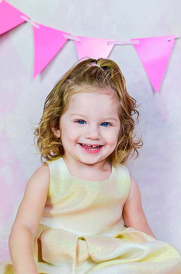 Gloria is registered to the contest to win money with this photo: baby, birthday, child, child_model, fashion_accessory, hair_accessory, happy, joy, party, party_hat, party_supply, person, photography, pink, smile, toddler, yellow