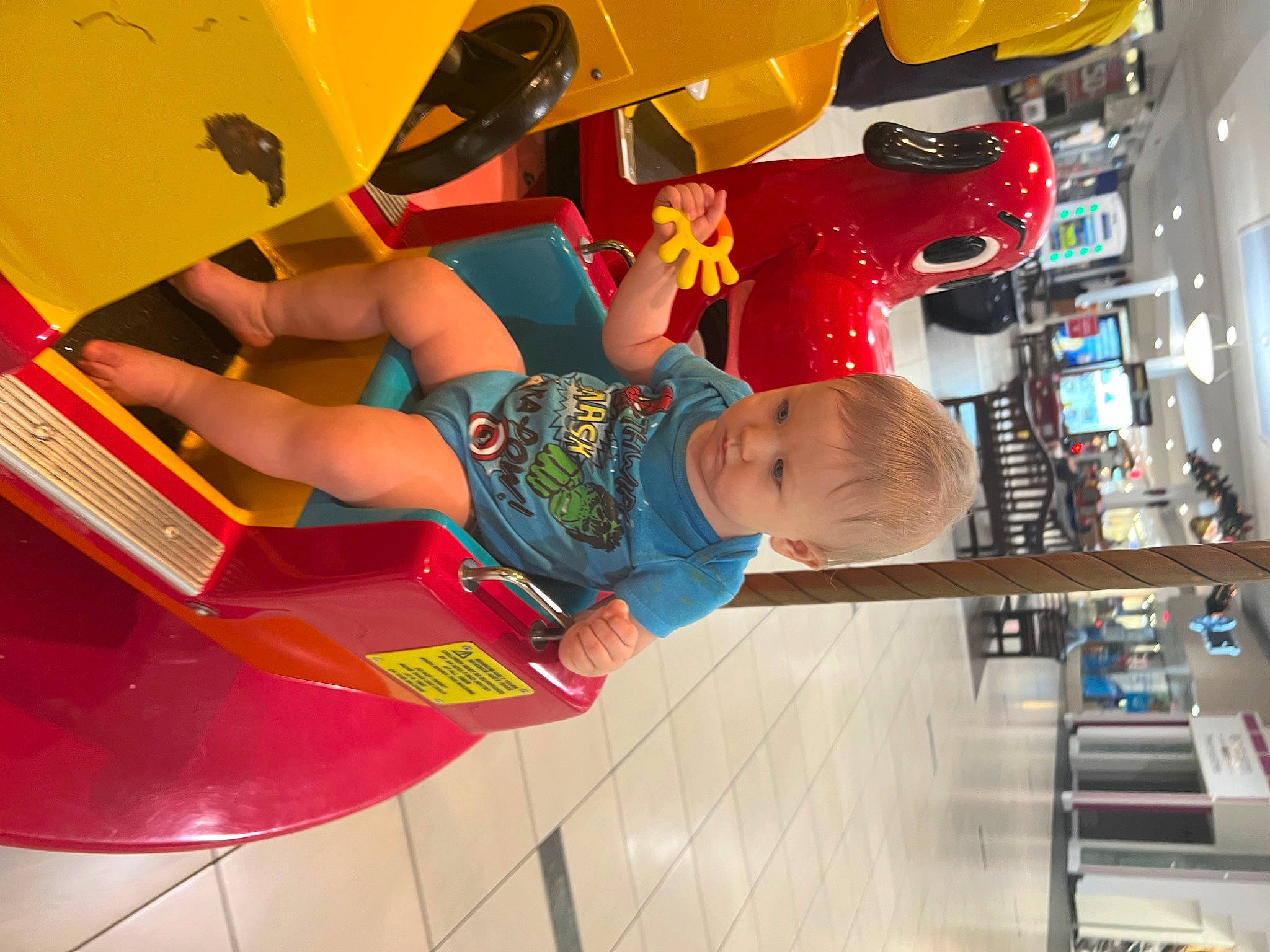 Kayson is registered to the contest to win money with this photo: automotive_design, automotive_exterior, carmine, child, fictional_character, fun, helmet, leisure, machine, person, play, recreation, red, retail, room, t_shirt, tire, toddler, toy, visual_arts