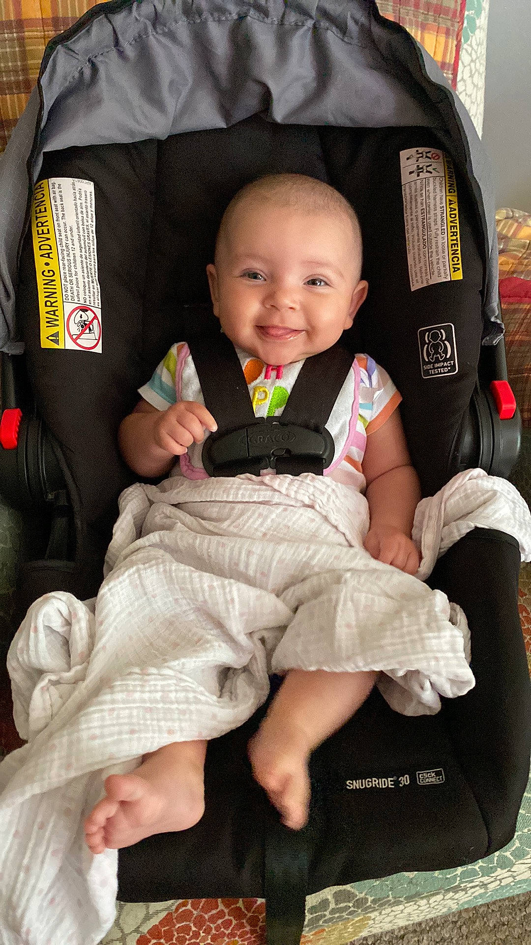 Mercy is registered to the contest to win money with this photo: baby, baby_carriage, baby_products, baby_toddler_clothing, black, car_seat, cheek, comfort, happy, head, human, joy, lap, person, pink, product, sitting, skin, sleeve, smile